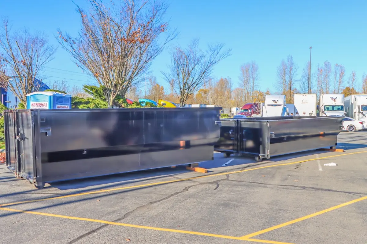 Professional dumpster rental service with roll-off container on residential driveway in Cortland